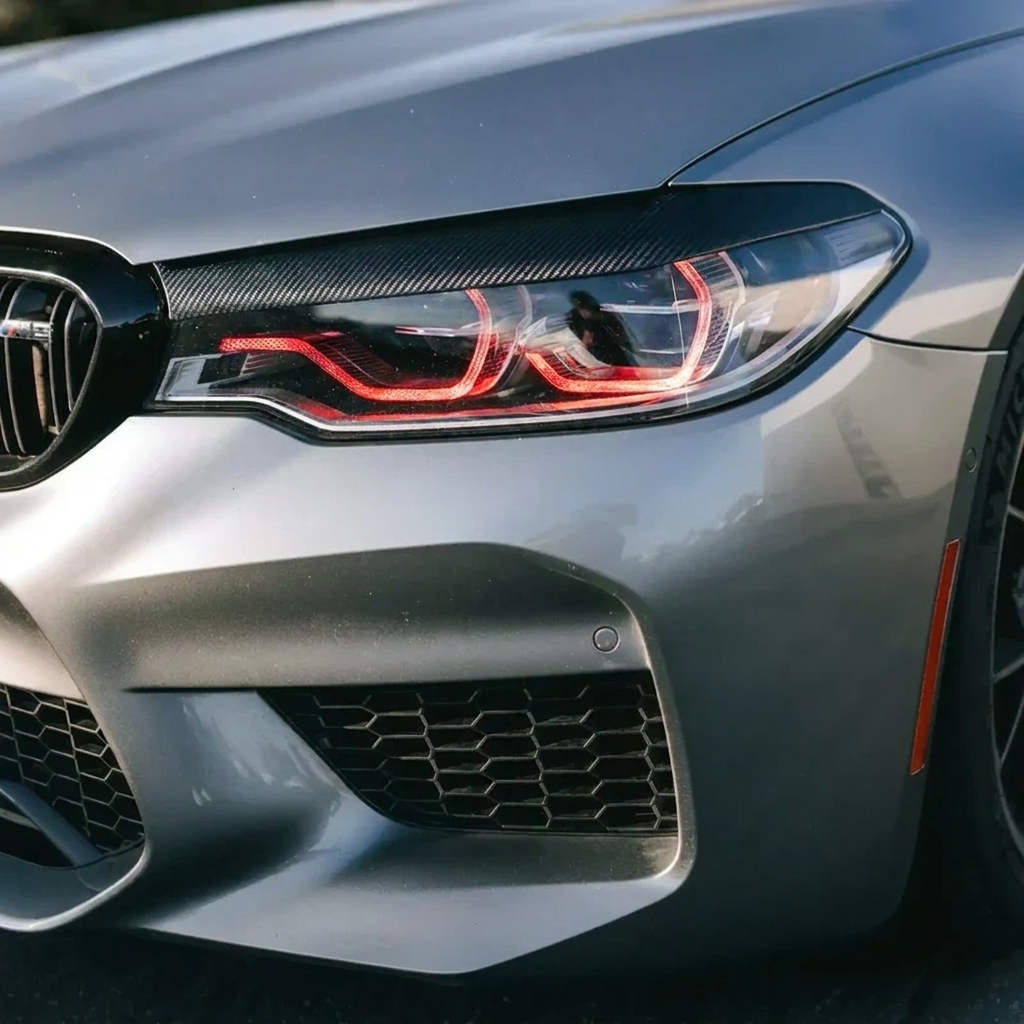 BMW F90 M5 red DRL headlight close up