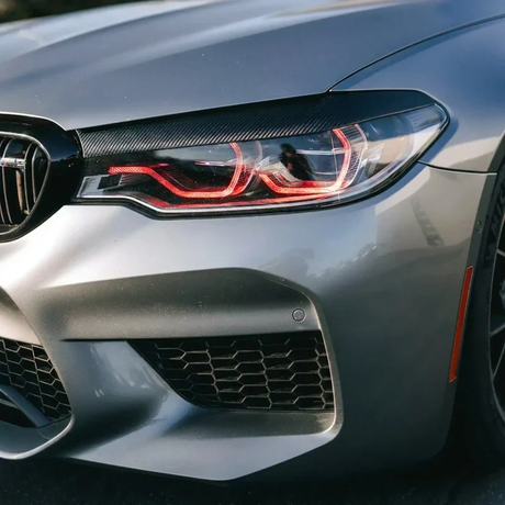 BMW F90 M5 red DRL headlight close up