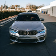 BMW F90 M5 with blue DRL kit installed - front view