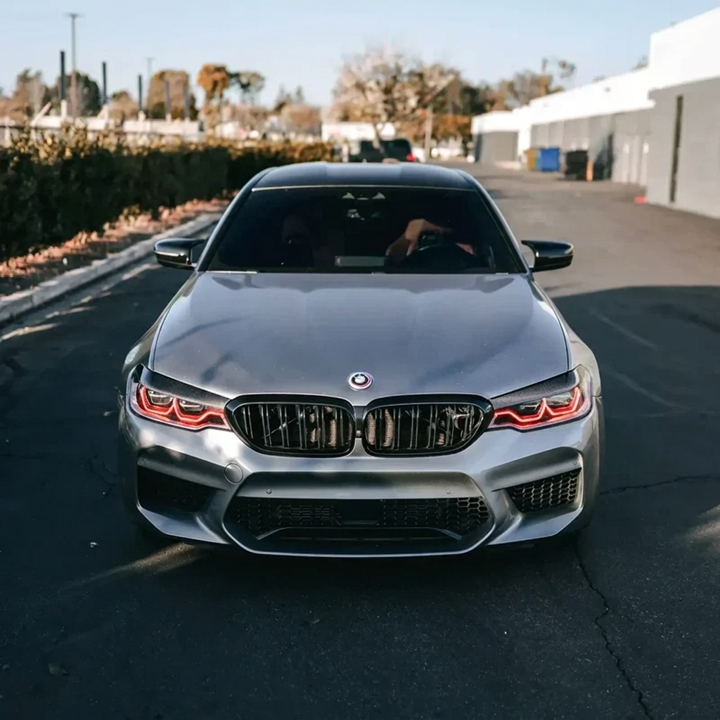 BMW F90 M5 with red DRL kit installed - front view