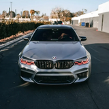 BMW F90 M5 with red DRL kit installed - front view