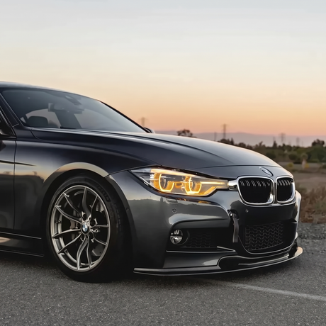 BMW F30 3 Series amber DRL three quarter view at sunset