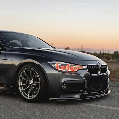 BMW F30 3 Series red DRL three quarter view at sunset