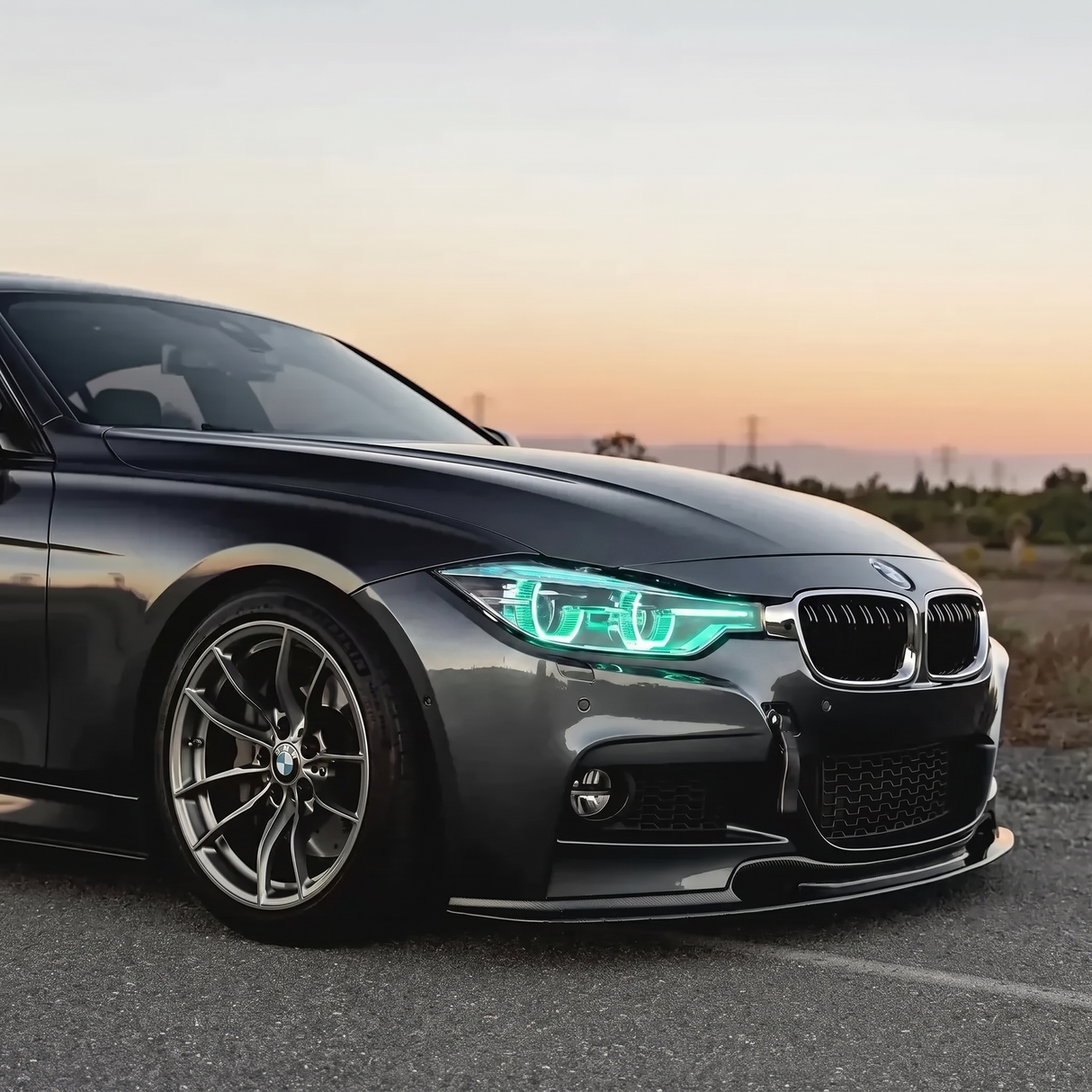 BMW F30 3 Series ice blue DRL three quarter view at sunset